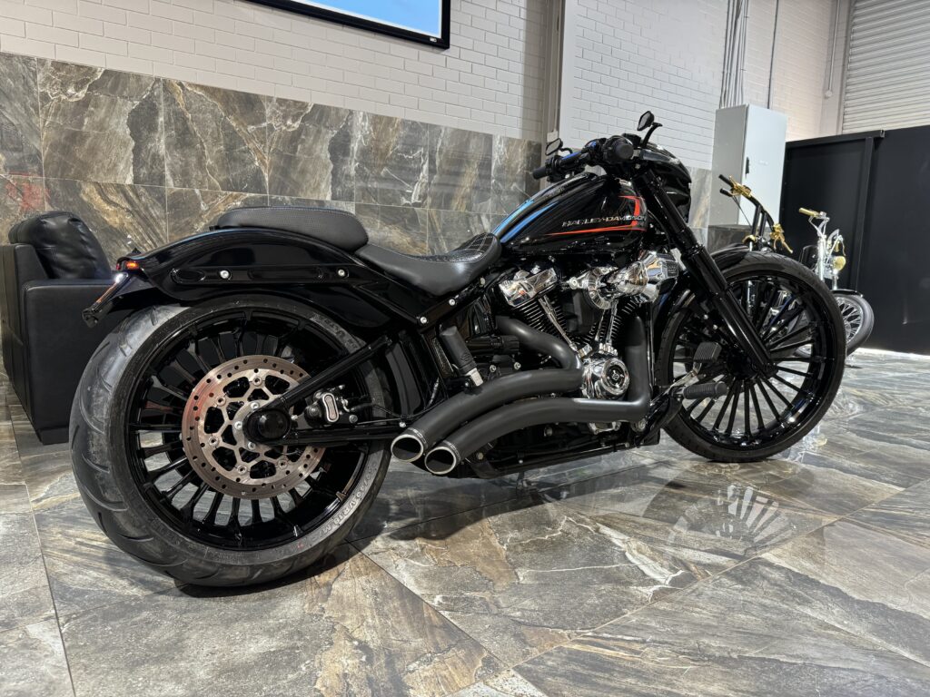 A modern black Harley Davidson parked in the Taverner Motorsports workshop.
